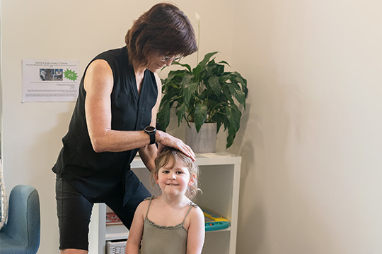 Chiropractor Toormina NSW Celia Burrows With Pediatric Patient